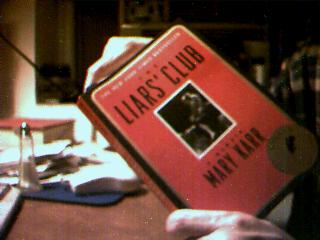 Picture of me pretending to read The Liar's Club in the near-dark